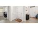 Welcoming foyer featuring neutral tiling, a storage rack, and a view into a bright, airy office space at 4119 Mossy Limb Ct, Palmetto, FL 34221