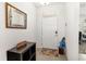 Inviting entryway with a charming mirror, shoe storage, and colorful rug, creating a welcoming atmosphere at 4119 Mossy Limb Ct, Palmetto, FL 34221