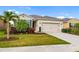 Well-manicured lawn and landscaping highlight this inviting home's charming exterior at 4119 Mossy Limb Ct, Palmetto, FL 34221