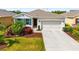 Beautiful exterior view of home featuring manicured landscaping, vibrant lawn, and two-car garage at 4119 Mossy Limb Ct, Palmetto, FL 34221