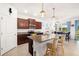 Kitchen with granite counters, dark cabinets, and barstool seating at the island at 4119 Mossy Limb Ct, Palmetto, FL 34221