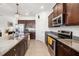 Modern kitchen features granite countertops and stainless steel appliances at 4119 Mossy Limb Ct, Palmetto, FL 34221