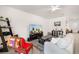 Comfortable living room with tile flooring, a ceiling fan, and a bright red chair at 4119 Mossy Limb Ct, Palmetto, FL 34221