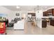 Open floor plan living area with kitchen, living, and dining spaces featuring tile floors at 4119 Mossy Limb Ct, Palmetto, FL 34221
