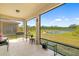 Relaxing screened patio with seating area and scenic views of the pond and landscaped backyard at 4119 Mossy Limb Ct, Palmetto, FL 34221