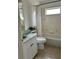 Neutral bathroom with shower and tub combo and single sink vanity with storage at 4217 N Chamberlain E Blvd, North Port, FL 34286