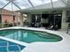 Backyard pool and patio area featuring a pool with step entry and comfortable lounge seating at 4217 N Chamberlain E Blvd, North Port, FL 34286