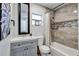 Well-lit bathroom with a single vanity, framed mirror, tiled shower with tub, and neutral color palette at 4542 19Th S Ave, St Petersburg, FL 33711
