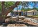 Charming home featuring a cozy front yard with a fire pit and comfortable seating area at 4542 19Th S Ave, St Petersburg, FL 33711