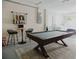 Finished basement boasts a pool table, bar stools, and a cozy lounge area with laundry in the background at 4549 Mcintosh Ln, Sarasota, FL 34232