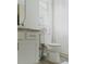Bright bathroom with modern toilet, granite countertop vanity, and a shower with white curtain at 4549 Mcintosh Ln, Sarasota, FL 34232