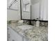 Modern bathroom featuring granite countertops, white cabinets, and a stylish soap dispenser at 4549 Mcintosh Ln, Sarasota, FL 34232