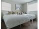 Bright bedroom featuring two beds, neutral decor, soft carpet, and a large window for natural light at 4549 Mcintosh Ln, Sarasota, FL 34232