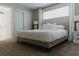 Spacious bedroom featuring a tufted headboard, plush carpet, and ample natural light from a window at 4549 Mcintosh Ln, Sarasota, FL 34232