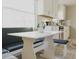 Bright eat-in kitchen with white cabinets, stainless appliances, and a cozy breakfast nook at 4549 Mcintosh Ln, Sarasota, FL 34232