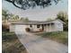 Charming single-story home with a one-car garage and well-maintained front yard at 4549 Mcintosh Ln, Sarasota, FL 34232