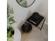 Stylish console table with decor featuring black accents, a round mirror, and a plant at 4549 Mcintosh Ln, Sarasota, FL 34232