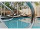 Inviting in-ground pool featuring a screened enclosure, lounge chairs, and privacy fence at 4549 Mcintosh Ln, Sarasota, FL 34232