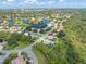 Aerial view showing the community's lush landscaping, tranquil lake, and many beautiful homes at 4625 Deer Creek Blvd, Sarasota, FL 34238