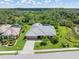 Well-manicured landscaping surrounds this Sarasota home with a concrete driveway and gray tile roof, offering both beauty and durability at 4625 Deer Creek Blvd, Sarasota, FL 34238