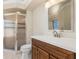 Bathroom with a glass door shower, wood vanity, white countertop, sink, and a toilet at 4625 Deer Creek Blvd, Sarasota, FL 34238