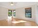 Bedroom with hardwood floors, ceiling fan, and three large windows for natural light at 4625 Deer Creek Blvd, Sarasota, FL 34238