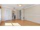 Bedroom with light hardwood floors, crown molding, closet, and an entrance to the bathroom at 4625 Deer Creek Blvd, Sarasota, FL 34238