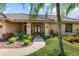Beautiful home exterior with a well-manicured lawn, lush tropical landscaping, and a welcoming front entrance at 4625 Deer Creek Blvd, Sarasota, FL 34238