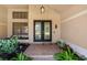 Elegant front entrance with double doors, manicured landscaping, and brick walkway at 4625 Deer Creek Blvd, Sarasota, FL 34238