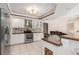 Kitchen featuring stainless steel appliances, granite countertops, white cabinetry, and tile flooring at 4625 Deer Creek Blvd, Sarasota, FL 34238