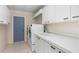 Laundry room with plenty of storage, a utility sink, and modern washer and dryer at 4625 Deer Creek Blvd, Sarasota, FL 34238