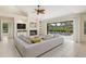 Open living room with fireplace, ceiling fan and access to screened pool area at 4625 Deer Creek Blvd, Sarasota, FL 34238