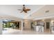 Bright open floor plan includes a modern kitchen with a bar, a dining area, and access to the pool area at 4625 Deer Creek Blvd, Sarasota, FL 34238
