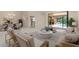 Bright living room with neutral tones, stylish furniture, and seamless access to the outdoor pool area at 4625 Deer Creek Blvd, Sarasota, FL 34238