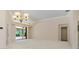 Spacious living area with neutral carpet, slider doors to lanai, and adjoining doorway at 4625 Deer Creek Blvd, Sarasota, FL 34238