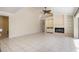 Open living room with fireplace, ceiling fan and access to other areas of home at 4625 Deer Creek Blvd, Sarasota, FL 34238