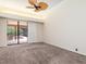 Main bedroom with ceiling fan and sliding doors to screened in pool area at 4625 Deer Creek Blvd, Sarasota, FL 34238