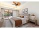 Main bedroom with ceiling fan and sliding doors to screened in pool area at 4625 Deer Creek Blvd, Sarasota, FL 34238