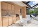 Outdoor kitchen space featuring a sink and a grill with patio furniture for lounging at 4625 Deer Creek Blvd, Sarasota, FL 34238