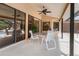 A covered patio with dining table set, ceiling fan, and sliding glass doors at 4625 Deer Creek Blvd, Sarasota, FL 34238