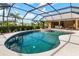 Outdoor swimming pool and spa with large screened-in enclosure and tropical landscaping at 4625 Deer Creek Blvd, Sarasota, FL 34238