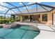 Screened-in pool and hot tub with a covered patio and outdoor dining table at 4625 Deer Creek Blvd, Sarasota, FL 34238