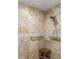 Close-up of a tiled shower with a shower head and a built-in corner seat at 4625 Deer Creek Blvd, Sarasota, FL 34238