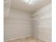 Walk-in closet features ample shelving and tile flooring at 4625 Deer Creek Blvd, Sarasota, FL 34238