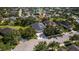 Aerial view of a residential neighborhood with mature trees and a serene lake in the background at 4712 Charles Partin Dr, Parrish, FL 34219