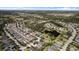 An aerial shot showcasing a peaceful community near a scenic lake, surrounded by lush greenery and well-spaced residences at 4712 Charles Partin Dr, Parrish, FL 34219