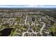 Overhead perspective of a charming neighborhood, complete with tranquil lakes, tree-filled parks, and inviting residences at 4712 Charles Partin Dr, Parrish, FL 34219