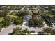 High-angle shot of a home in a suburban setting, with a well-kept lawn and tree-lined streets nearby a small lake at 4712 Charles Partin Dr, Parrish, FL 34219