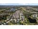 Sprawling suburban neighborhood aerial view, featuring a mix of homes and tranquil lake views, shaded by mature trees at 4712 Charles Partin Dr, Parrish, FL 34219