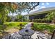 Picturesque backyard featuring a cozy patio, lush lawn, and mature trees, offering a perfect space for outdoor relaxation at 4712 Charles Partin Dr, Parrish, FL 34219